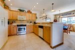 Kitchen with full-size refrigerator, oven, microwave, dishwasher and small appliances
